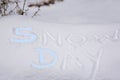 SNOW DAY fingerpainted in snow with first letters in blue Royalty Free Stock Photo