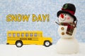 Snow Day message with happy snowman with hat, school bus, and snow Royalty Free Stock Photo