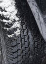 Snow on the deep safe tread of a roadworthy tire in winter time Royalty Free Stock Photo