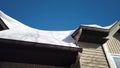 Snow drifted on home roof. Roof of the chalet or cottage in residential community under the weight of snow. House in snowy and win