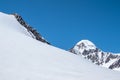 Snow drifts on a mountain slope. Atmospheric mountain landscape with glacier on rocky hill. Awesome scenery with stony pass with Royalty Free Stock Photo