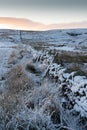 Snow on a dry stone wall on a Northumberland moor Royalty Free Stock Photo