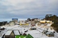 Snow fall and bright sunlight , a scintillating view with bluish cloudy sky and green pine tree