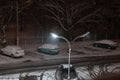 Snow falling night against the background of a lamppost
