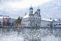 Snowfall in lucerne Reuss river with swiss buildings coverd in snow