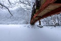 Snow falling in park and a walking bridge in winter. Royalty Free Stock Photo
