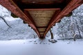 Snow falling in park and a walking bridge in winter. Royalty Free Stock Photo