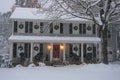 Snow falling on a suburban home decorated for Christmas Royalty Free Stock Photo