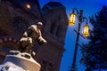 Snow Falls Heavily on this Night Time scene of the Basilica of St. Francis and St. Francis of Assisi Statue in Santa Fe New Mexico