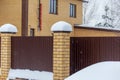 Snow on the fence of a country house in winter Royalty Free Stock Photo