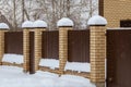 Snow on the fence of a country house in winter Royalty Free Stock Photo