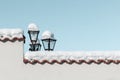 Snow on fence of house and lantern, blue sky on sunny day on street of town. Winter concept, background, copy space Royalty Free Stock Photo