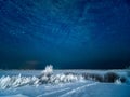 Snow at field and starry moonless winter sky