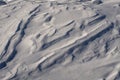 Snow fields covered with intricate patterns from the wind, a copy space, close-up. Royalty Free Stock Photo
