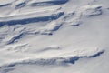 Snow fields covered with intricate patterns from the wind, a copy space, close-up.