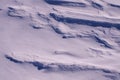 Snow fields covered with intricate patterns from the wind, a copy space, close-up, toned. Royalty Free Stock Photo