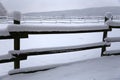 Fresh snow filled corral fences at rural winter snowy horse farm