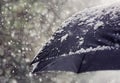 Snow flakes falling on umbrella Royalty Free Stock Photo