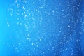 Snow flakes falling on blue background. Royalty Free Stock Photo