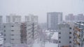 Snow flakes falling over houses