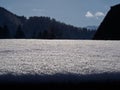 Snow on the floor reflect the sunlight on the mountain background in sunny day