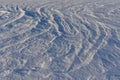 Snow on a frozen lake blown by wind creating a pattern