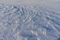 Snow on a frozen lake blown by wind creating a pattern