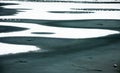 The snow and frozen lake form a pattern of light and darkness. Royalty Free Stock Photo