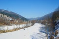 Snow on a frozen river in a mountain village in early spring Royalty Free Stock Photo