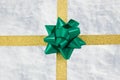 Snow gift with golden ribbon Royalty Free Stock Photo