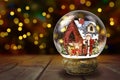 Snow Globe Against Christmas Lights Background Royalty Free Stock Photo