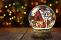 Snow Globe Against Christmas Lights Background Royalty Free Stock Photo