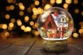 Snow Globe Against Christmas Lights Background Royalty Free Stock Photo