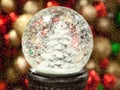Christmas Globe with Tree and Snow with Colorful Bulbs in Background