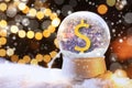 Snow globe with dollar sign and blurred Christmas lights on background. Space for text Royalty Free Stock Photo