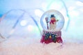 Snow globe with happy snowman blured background Royalty Free Stock Photo