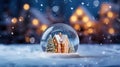 Snow globe with tiny modern house inside near big real cozy house with lights in windows in winter. Gift dream for Christmas, New