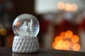 Snow globe on wooden table against blurred background. Bokeh effect Royalty Free Stock Photo