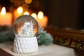 Snow globe on wooden table against blurred background. Bokeh effect Royalty Free Stock Photo