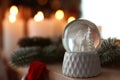 Snow globe on wooden table against background. Space for text Royalty Free Stock Photo