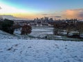 Snow greenwich observatory hill building clear view London city skyline banking district orange warm light sunset sundow Royalty Free Stock Photo
