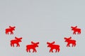 Snow grey background with red moose silhouettes border. Minimalist Christmas background. Royalty Free Stock Photo