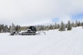 Snow groomer prepares ski cross-country route, ski track on fre