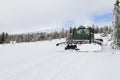 Snow groomer prepares ski cross-country route, ski track on fre