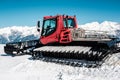 Snow grooming machine Ratrak. Winter mountain landscape.