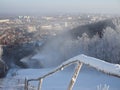 Snow gun making artificial snow in morning, on back fir forest. Snowmaking by water through snow cannon for snow cover