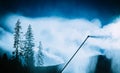 Snow gun, snow making process on a ski slope. Climate control wi