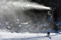 Snow Gun Snowmaker throw snow over a snowboarder in Whakapapa skifield Royalty Free Stock Photo