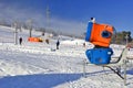 Snow-gun working on a ski slope.Working snowgun in the photo. Royalty Free Stock Photo