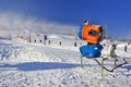 Snow-gun working on a ski slope.Working snowgun in the photo. Royalty Free Stock Photo